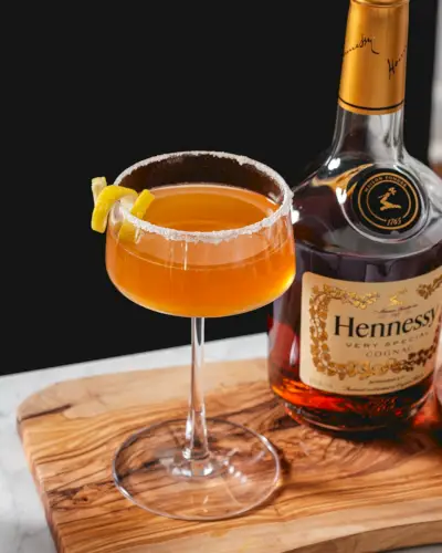 Recept na Hennessy Sidecar v koktailovom pohári s citrónovým twistom a cukrovým okrajom