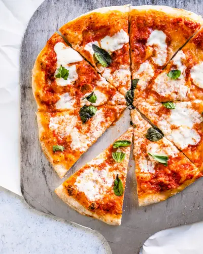 Neapolská pizza na slupce s bazalkou a čerstvou mozzarellou.
