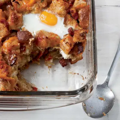 Colazione al forno con pancetta, pomodoro e formaggio cheddar con uova