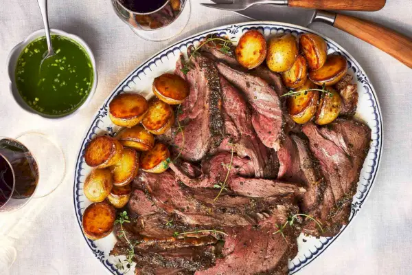 Pierna de cordero cocinada sobre patatas nuevas con salsa picante de menta y ron