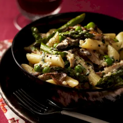 Penne con espárragos, guisantes, champiñones y nata