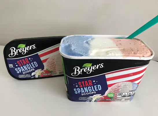 an open container of red white and blue ice cream