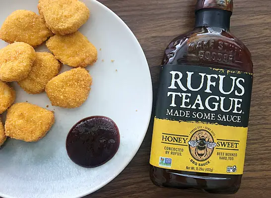 rufus teague bbq sauce next to plate of chicken nuggets