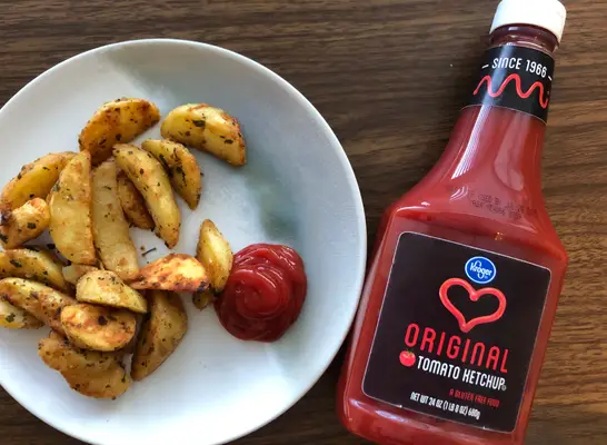 kroger ketchup bottle with ketchup on a plate.