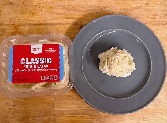 a container of market pantry potato salad next to a dish of potato salad