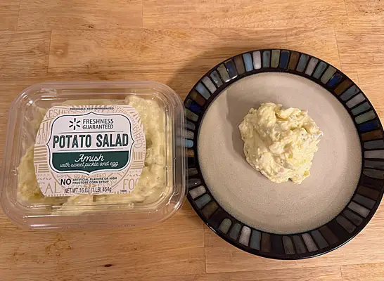 a container of walmart amish potato salad next to a dish of potato salad