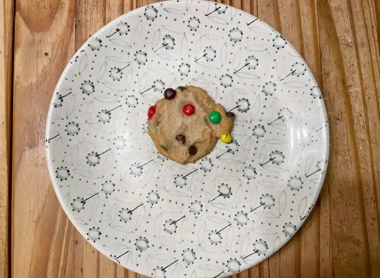 nestle m and m cookie on a printed plate.