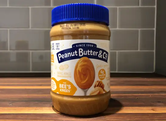peanut butter and co jar on a table.