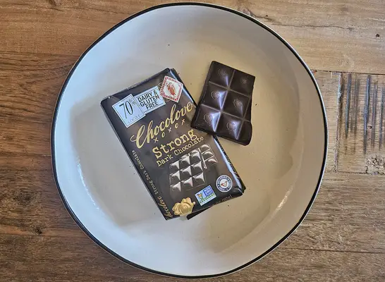 individually wrapped dove chocolates on a white plate with a dove bag.
