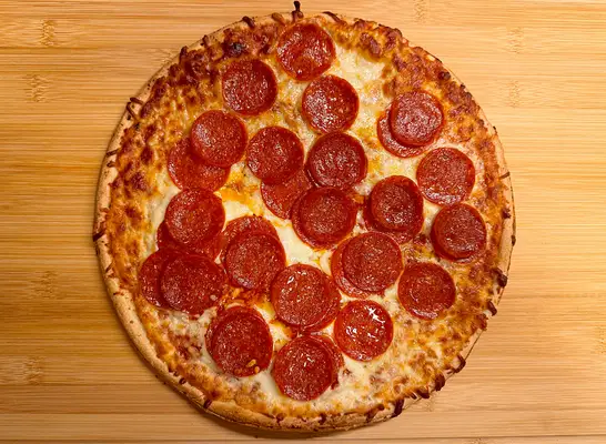 a pepperoni pizza ona cutting board.
