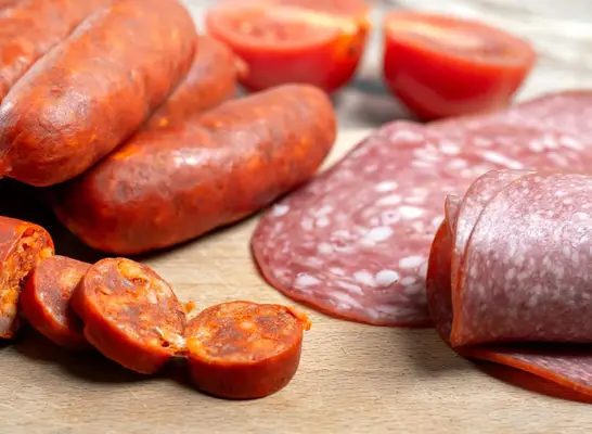 different types of processed red meat on a table