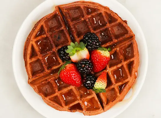 chocolate protein waffle with fresh berries on a plate