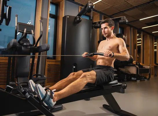 fit man indoor rowing, part of workout for V-taper back