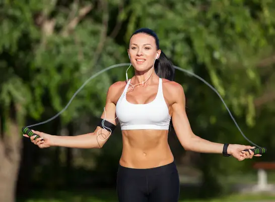 woman doing kettlebell swings, concept of strength exercises for women to melt middle-aged spread belly fat