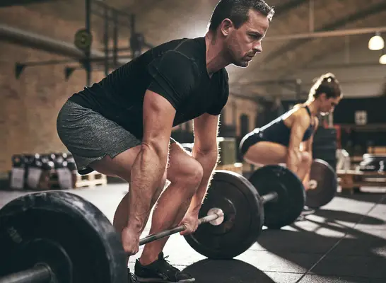middle-aged man doing deadlifts