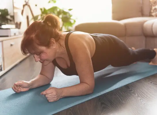mature woman doing planks, weight loss exercises you shouldn