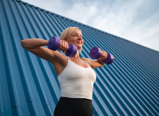 man grabbing dumbbells from rack at gym, close-up