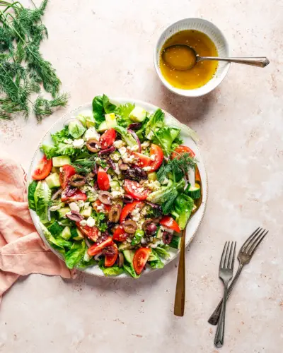 Mediterranes Salatrezept auf Teller mit Vinaigrette-Dressing.