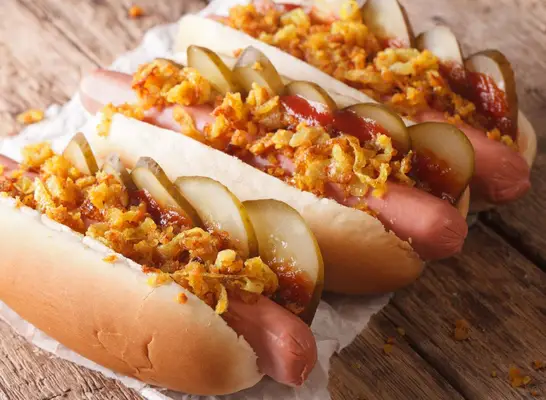 hot dog with crispy onions and bbq sauce