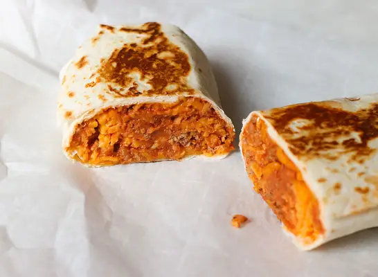 Cutting open a Taco Bell copycat chili cheese burrito