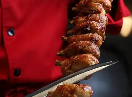 Skewered steaks on the grill at Steak Brasil restaurant