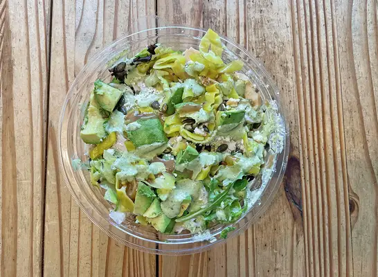 The new Balsamic Chicken Greens with Grains from Panera Bread upon a wooden table