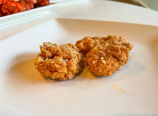 two garlic parm wings on a plate.