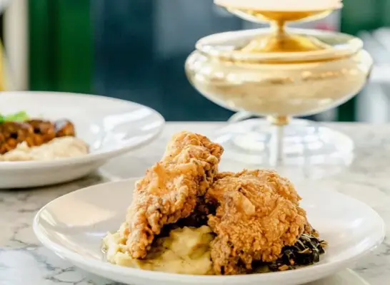 Chick Chick fried chicken sandwich held aloft in New York City
