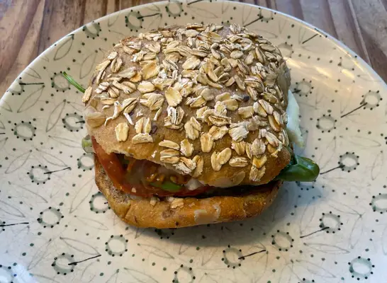 panera avocado and egg white sandwich on a printed plate.
