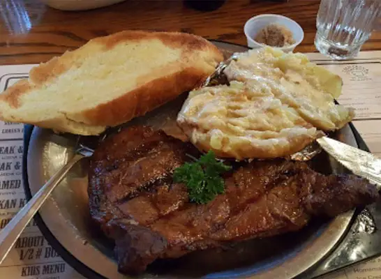 plated steak with bread and mashed potatoes