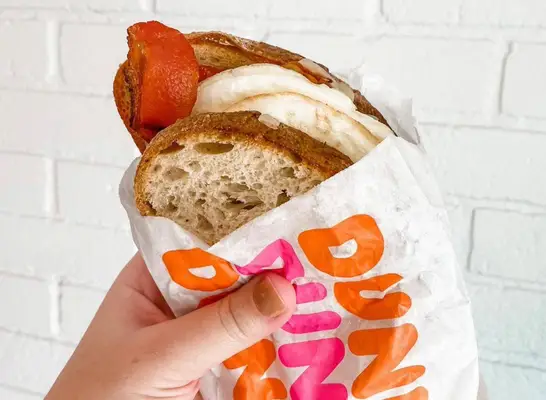 person holding dunkin