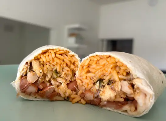 an el pollo loco burrito cut open on a countertop