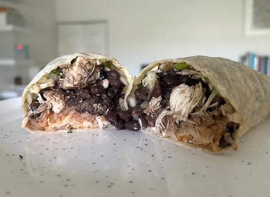a baja fresh burrito cut open on a countertop