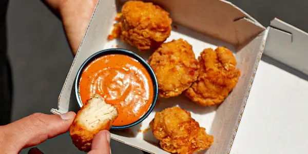 person dipping taco bell