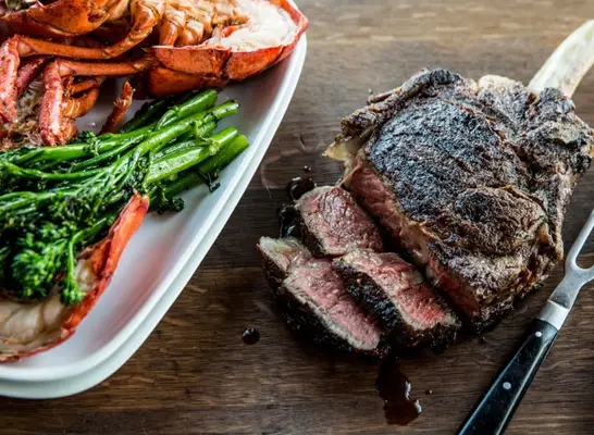 Two steaks with side dishes from Grecian Steak House in Pickneyville, Ill.