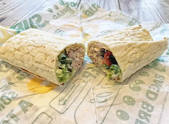 The new Homestyle Chicken Salad flatbread wrap from Subway, opened upon its wrapper