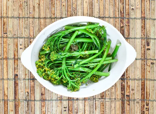 broccolini cooked in white dish