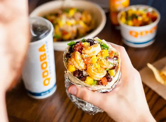 person holding qdoba