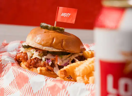 Hot chicken sandwich with slaw at Hattie B