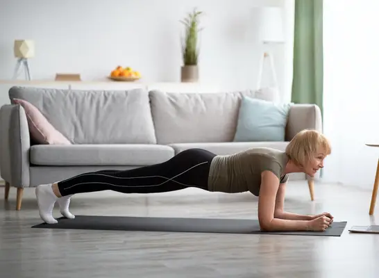 woman doing planks exercise in living room