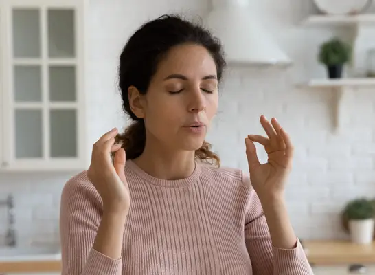 woman deep breathing exercise in kitchen before eating, concept of how to lose 10 pounds quickly