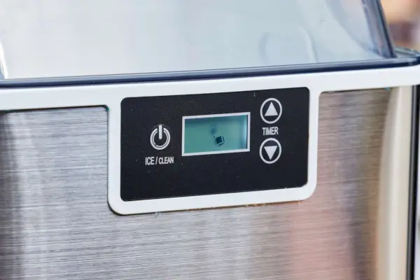 Un primer plano del botón de encendido y el temporizador de la máquina de hielo Frigidaire Countertop Nugget Ice Maker V2