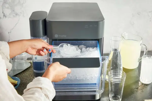 Persona sacando hielo junto a la máquina de hielo