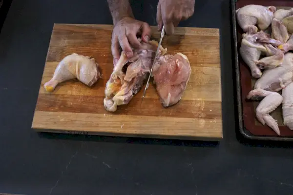 Personne utilisant un couteau de boucher lourd Global GF-27-7 de 7 pouces pour couper de la viande