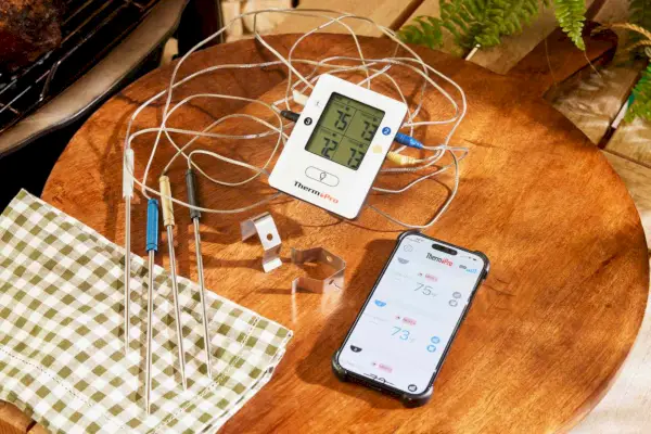 Termometr do mięsa ThermoPro TP25 z 4 sondami jest wyświetlany na drewnianej patelni