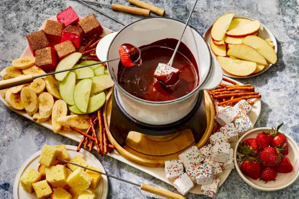 Kořeněné čokoládové fondue s naběračkami, jako jsou jablka, banány a marshmallows