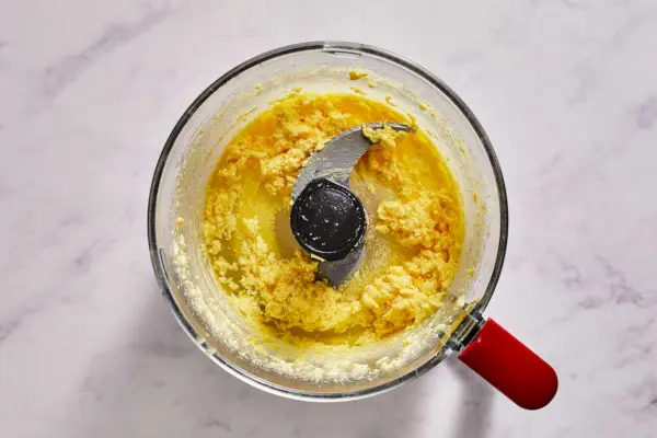 Eine Küchenmaschine mit Butter, Zucker, Orangenschale und Orangensaft