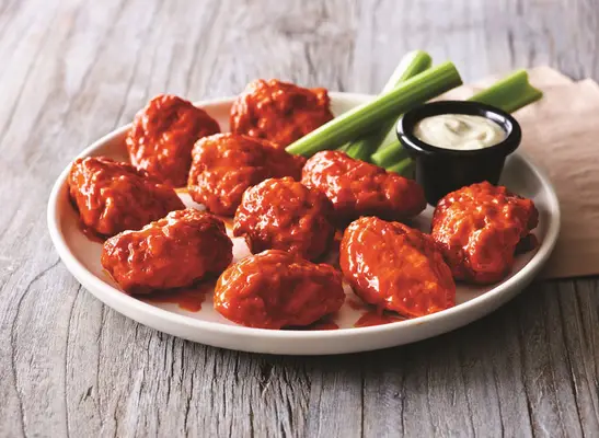 applebees boneless buffalo wings with dip on white plate