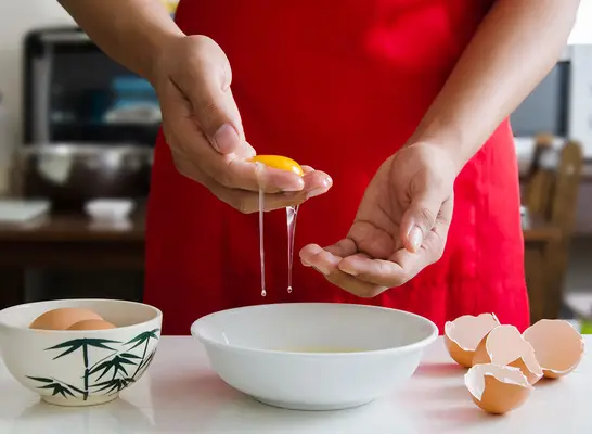 Separating egg whites with hands