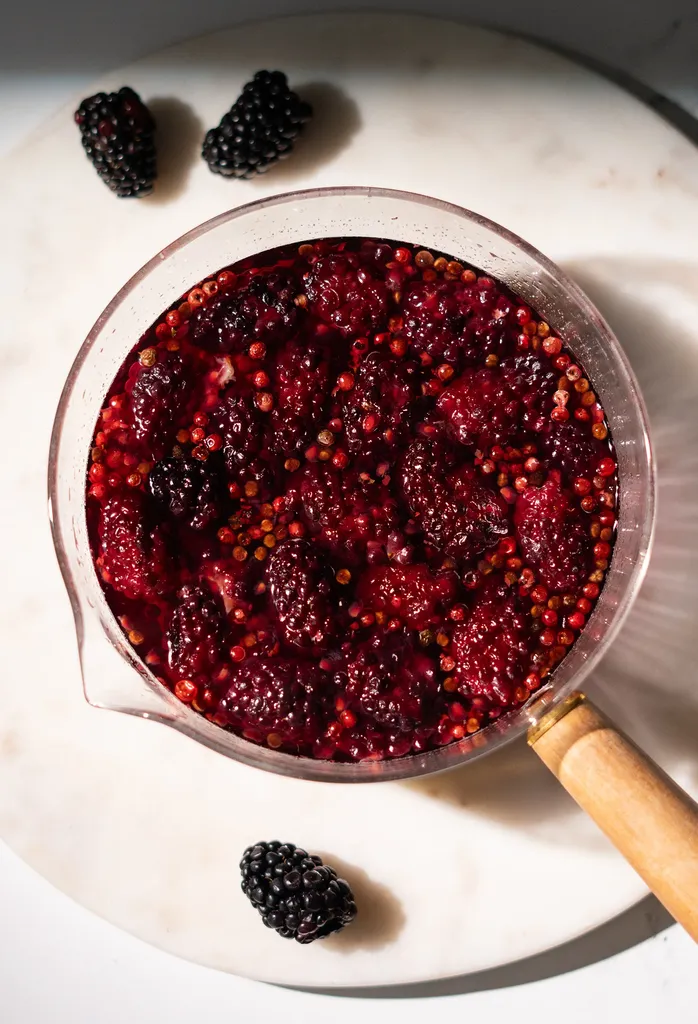 ガラスの鍋にブラックベリーとピンクペッパーを赤いシロップで入れたもの。' title=